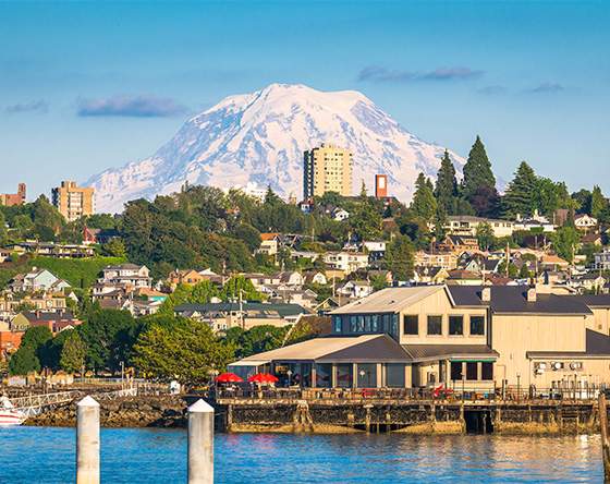 locally owned - beautiful cityscape with snow capped mountains in the distance